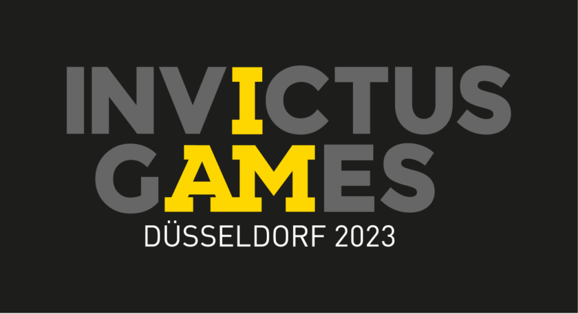 In grauer Schrift auf schwarzem Hintergrund steht Invictus Games . Darunter Düsseldorf 2023. Die Buchstaben IAM sind gelb hervorgehoben.