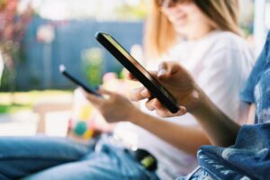 Details of two women using their phones